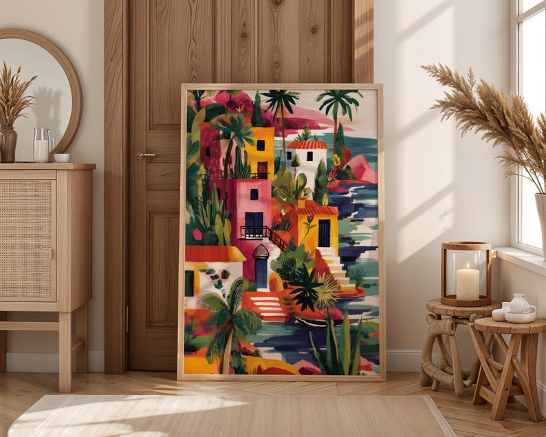 a vibrant, colorful painting of a tropical village, with palm trees, buildings, and water, displayed in a room with a wooden door and a mirror.