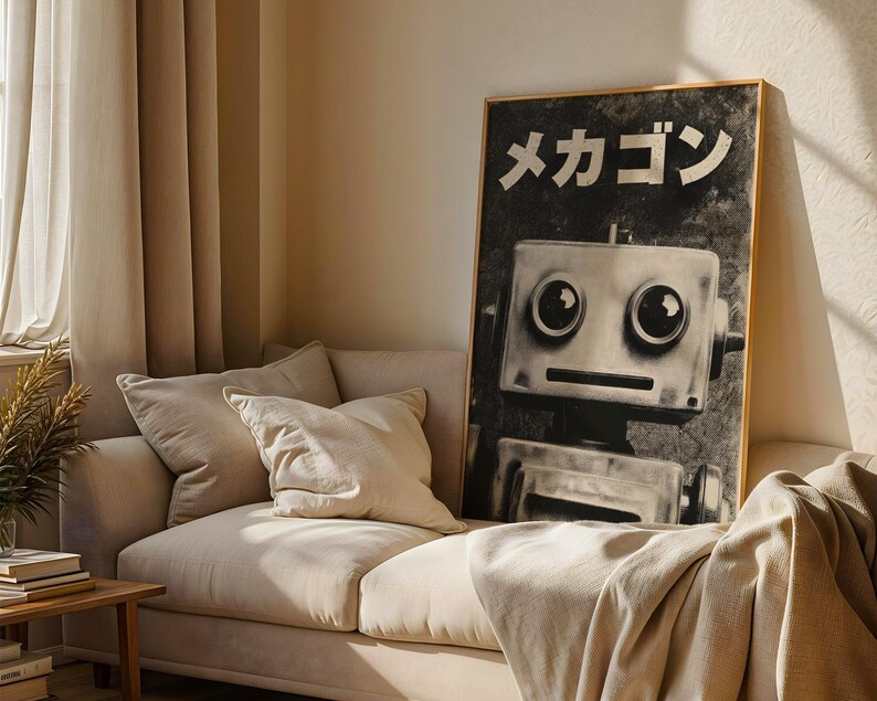 a large black and white poster of a robot on a wall, with a beige couch and a wooden side table in the foreground.