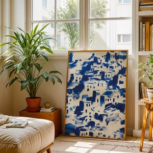 a cozy living room with a large blue and white abstract painting on the wall, a comfortable sofa, a wooden side table, and several potted plants.