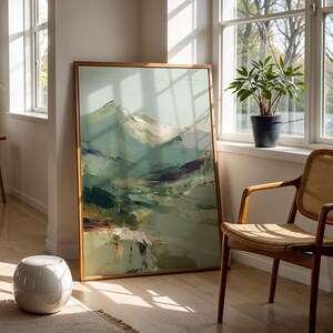 a large painting of a mountain landscape, a wooden chair, and a potted plant, all set against a bright, sunny background.