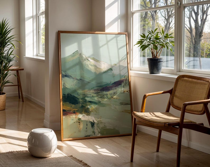 a large painting of a mountain landscape, a wooden chair, and a potted plant, all set against a bright, sunny background.