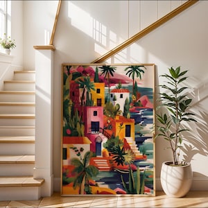 a colorful painting of a tropical village, with buildings, palm trees, and a body of water, displayed on a wall in a bright and sunny room with a staircase and potted plants.