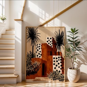 a large abstract painting of a building with palm trees, placed on a wall next to a staircase and a potted plant.