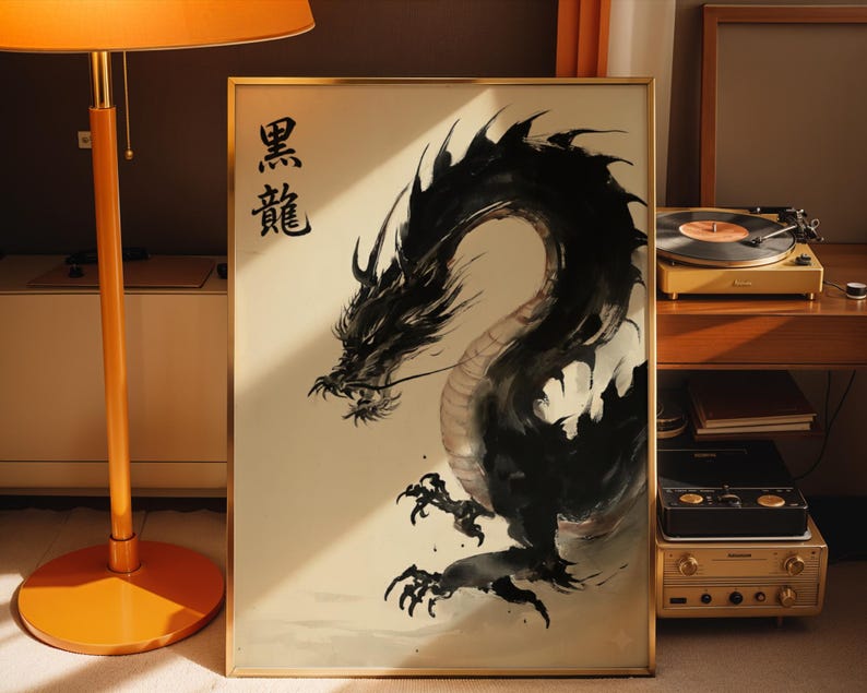 a framed artwork of a black dragon with Chinese characters above it, placed on a wooden surface next to a lamp and other electronic equipment.