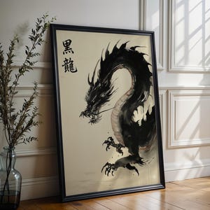 a large black dragon painting displayed on a wall, with a vase of greenery to the left.