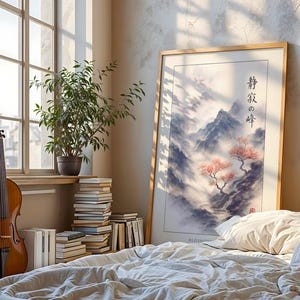 a serene bedroom scene with a large framed landscape painting of a mountain and trees, a wooden violin, and a stack of books on a bed.