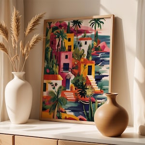 a vibrant painting of a tropical island scene, with colorful buildings, palm trees, and a body of water. The painting is framed and displayed on a shelf, accompanied by two white vases and a wooden sculpture.
