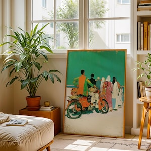 a living room with a large painting of a group of people on a motorcycle, a potted plant, a bookshelf, and a footrest.