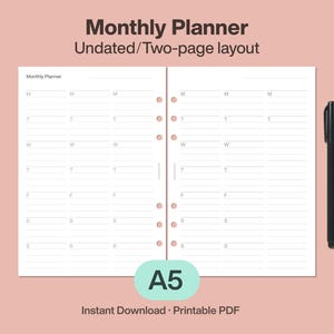 Puede incluir: Un planificador mensual sin fecha de dos páginas, tamaño A5, con un diseño de días de la semana etiquetados M, T, W, T, F, S y S. Un bolígrafo negro descansa a la derecha. El texto "Monthly Planner" y "Undated/Two-page layout" están en la parte superior.