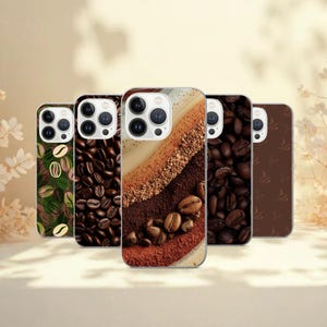 May include: A collection of five phone cases with coffee-themed designs. The cases feature images of coffee beans, coffee art, and coffee-related patterns in shades of brown, beige, and green. The cases are arranged in a row, showcasing the variety of designs.