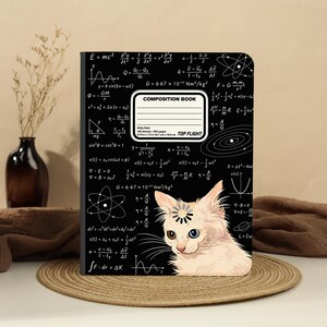 May include: A black composition book featuring a white scientific physics formula pattern and a central label reading COMPOSITION BOOK, Wide Rule, 100 Sheets, 200 pages, 9.75 in x 7.5 in, 24.7 cm x 19.0 cm, TOP FLIGHT. A light-colored cat with heterochromia sits at the bottom.
