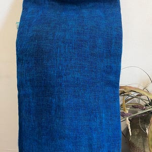 May include: A vibrant blue scarf with a textured appearance. The scarf is made of a soft material and has a fringed edge. The color is a deep, rich blue, perfect for adding a pop of color to any outfit.