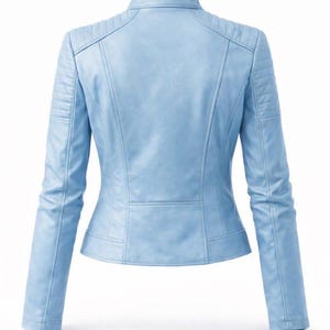 May include: A light blue leather jacket with a stand-up collar and quilted shoulder detailing. The jacket has a fitted silhouette with a slightly flared waist and long sleeves. The back view shows the jacket's design.