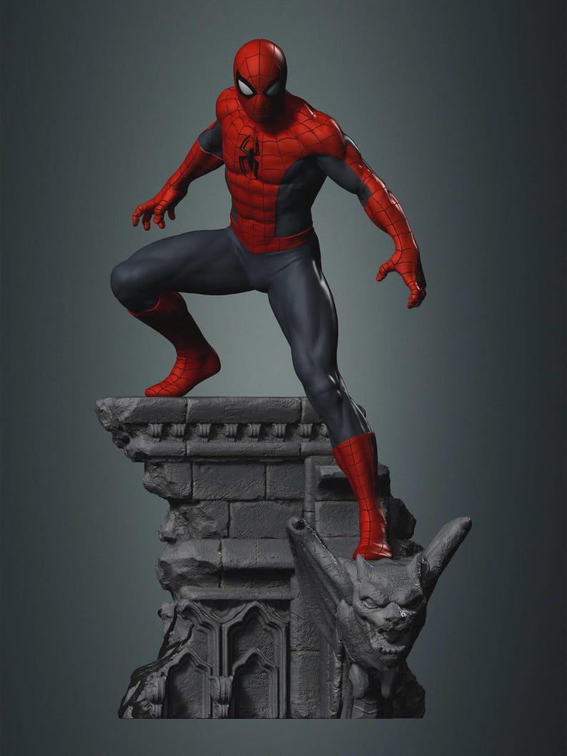 May include: A detailed statue of Spider-Man in a dynamic pose, wearing his classic red and blue suit. The figure is perched atop a gray, gothic-style stone structure with a gargoyle. The statue's pose suggests action and readiness.