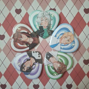 May include: Six heart-shaped badges with anime-style character illustrations. Each badge showcases a unique character design, with diverse hair colours and attire. The background features a diamond pattern in pink and white hues.