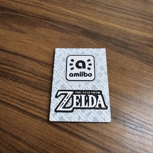 May include: A white ceramic mug with a black handle and the text "But First, Coffee" in a bold, black font. The mug is set against a neutral background, highlighting its simple design.