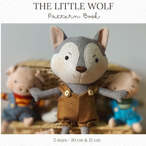 May include: A grey wolf plush toy wearing brown overalls with two buttons, featured on the cover of The Little Wolf Pattern Book by Melissa Rios studio. The text indicates 2 sizes, 30 cm & 12 cm, with two other plush toys visible in the background.