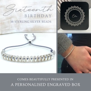 May include: A grey string bracelet with 16 sterling silver beads. The bracelet comes in a black box with a mandala design and the name "Ella" engraved on it. The box is for a 16th birthday.