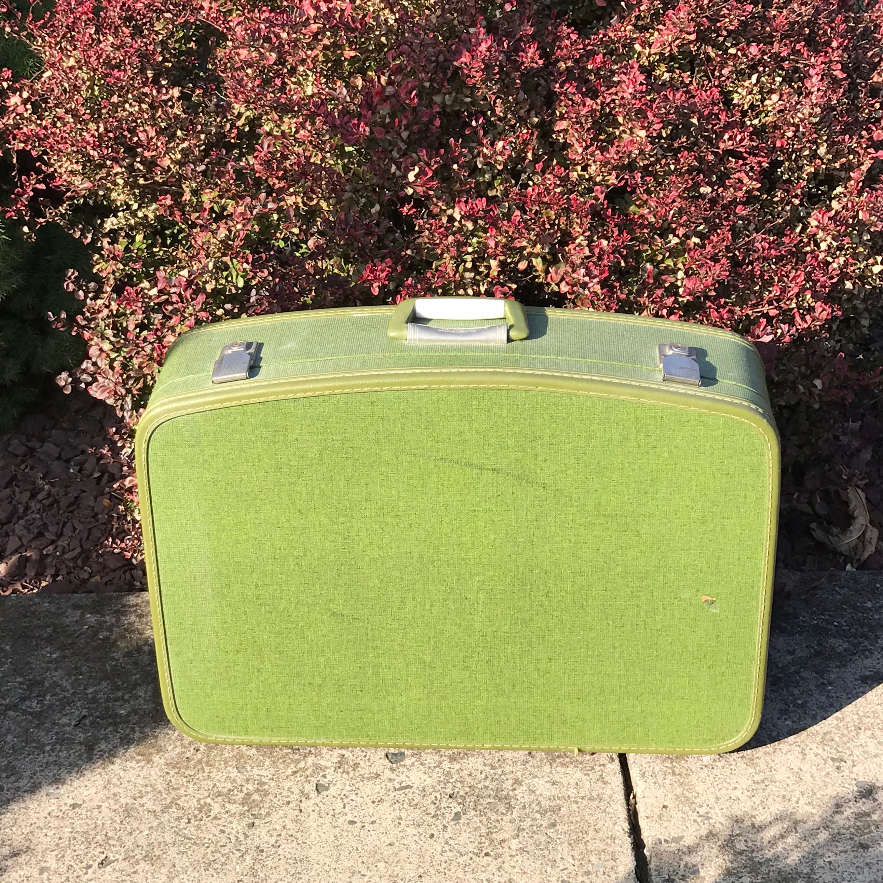 green hard shell luggage