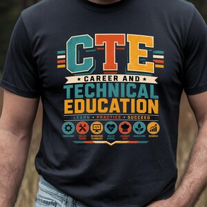 May include: Dark blue t-shirt featuring the text "CTE CAREER AND TECHNICAL EDUCATION" in a vibrant, multi-coloured design. The graphic includes icons representing different career paths. The words "LEARN PRACTICE SUCCEED" are also displayed.