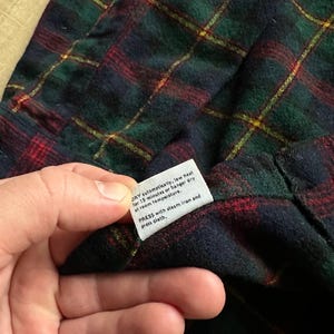 May include: A white ceramic mug with a black handle and the text "But First, Coffee" in a black, bold font. The mug is on a white surface. The mug is 4 inches tall.