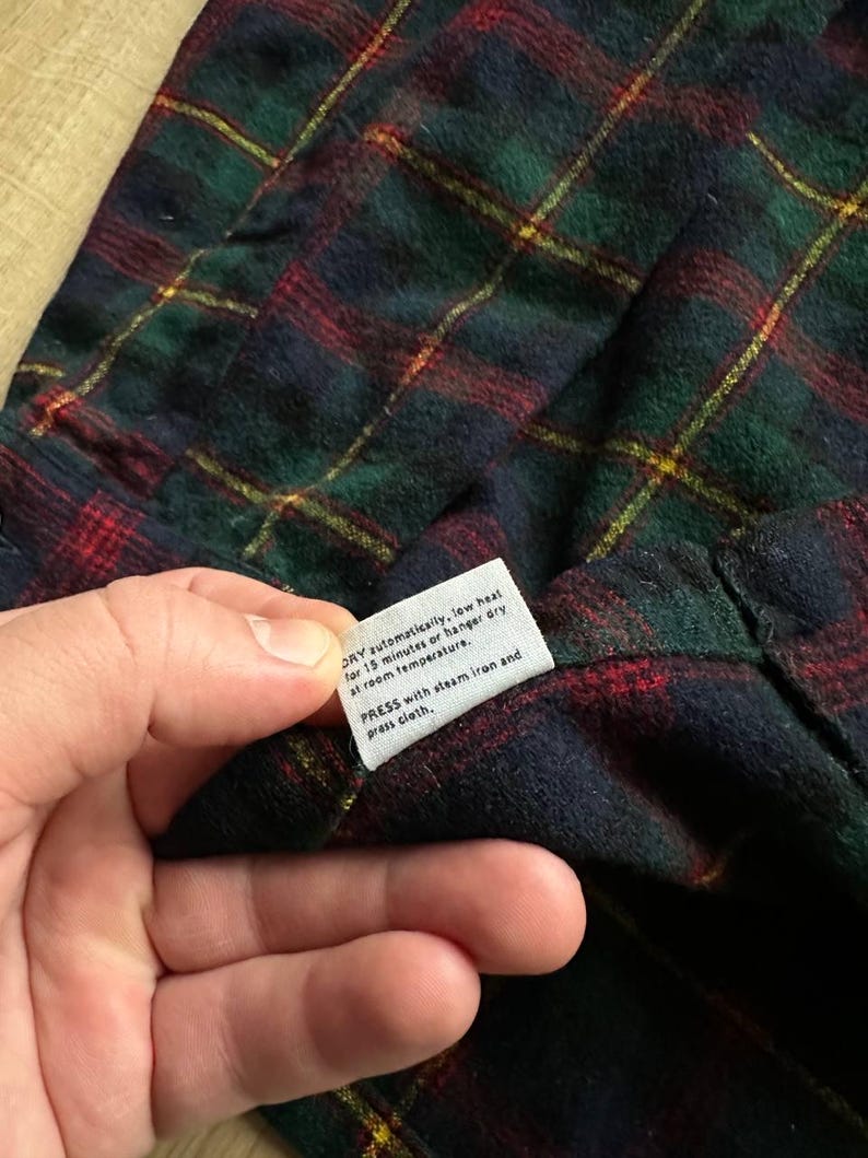 May include: A white ceramic mug with a black handle and the text "But First, Coffee" in a black, bold font. The mug is on a white surface. The mug is 4 inches tall.