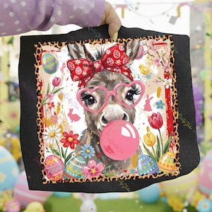 May include: A decorative Easter-themed square featuring a donkey with heart-shaped glasses blowing a bubblegum bubble. The donkey wears a red bow and headband. The design includes Easter eggs, flowers, and a leopard print border.