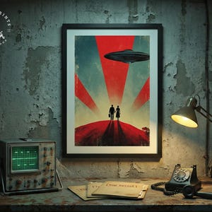 May include: Framed art print with a retro sci-fi illustration of a couple on a red hill with a UFO above. The print is in a black frame, displayed with a vintage oscilloscope, lamp, and telephone on a weathered surface.