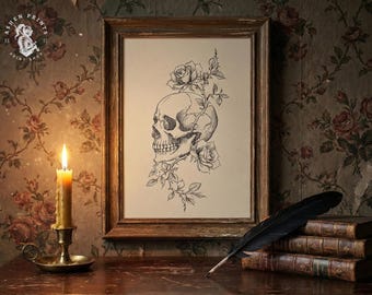 May include: A framed monochrome illustration of a human skull entwined with roses and vines. The artwork is on a wooden table with a lit candle and books. A black feather quill rests on the books.