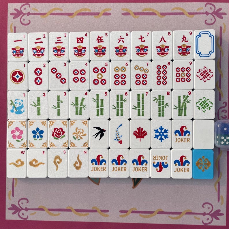 May include: A set of white mahjong tiles arranged in a grid, featuring red Chinese numerals with lion faces, red and blue circular patterns, green bamboo stalks, a panda, floral designs, a bird, a fish, a maple leaf, a snowflake, and joker tiles.