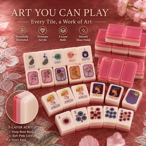 May include: A set of Mahjong tiles with a 3-layer acrylic design. The tiles feature illustrations and text, including "EAST", "WEST", "SOUTH", and "JOKER". The set includes pink and white tiles with a smooth gloss finish. The text "ART YOU CAN PLAY" is also visible.
