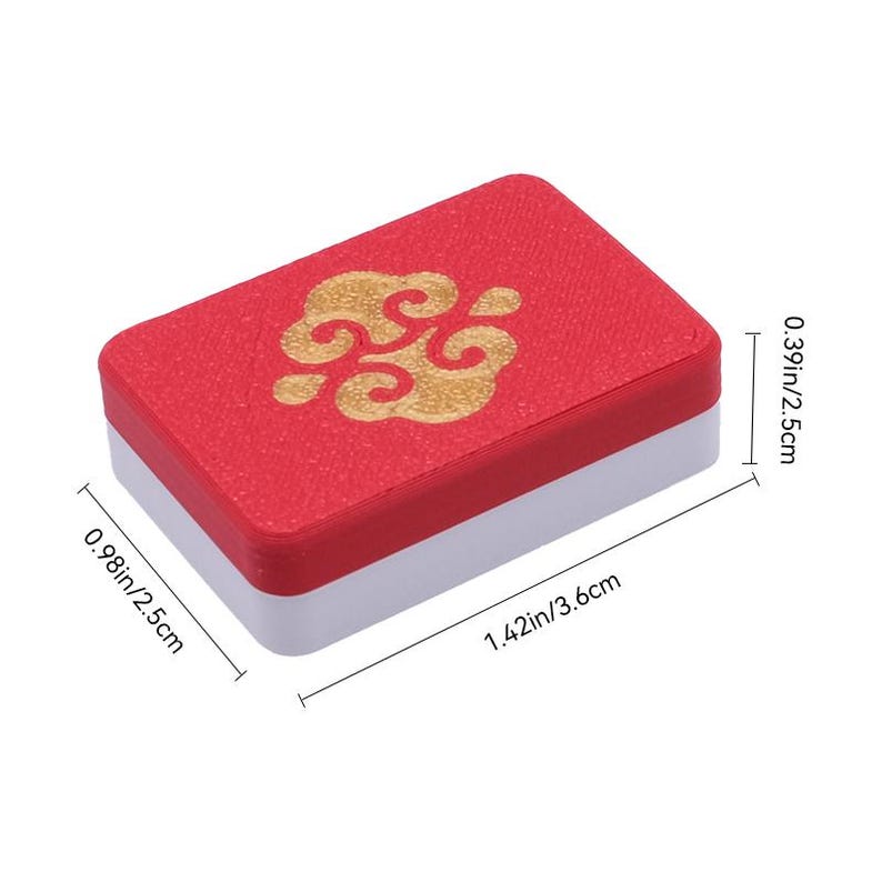 May include: A rectangular box with a red lid featuring a gold cloud-like emblem and a white base. The box measures 0.98 inches by 1.42 inches by 0.39 inches as indicated by the visible dimension lines and text labels on the image.
