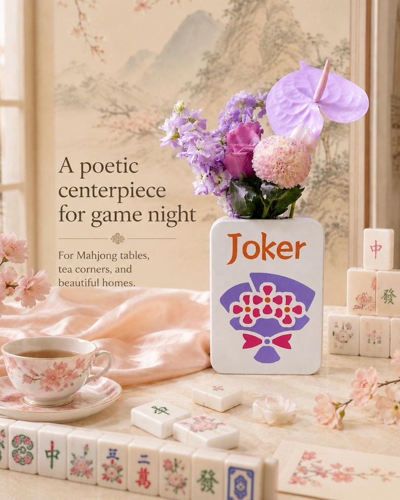 May include: A floral arrangement in a white vase with the word "Joker" and a floral design. The arrangement includes purple, pink, and green flowers. Mahjong tiles and a teacup with a floral design are also visible.