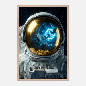 May include: A framed print featuring an astronaut in a spacesuit. The astronaut's gold-tinted helmet reflects a vibrant blue nebula. The spacesuit is white and gray, set against a dark starry background.