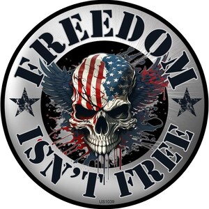 May include: A round, silver-colored graphic with the words "FREEDOM ISN'T FREE" encircling a skull. The skull is painted with the American flag design, with wings and blood splatter details. Two star shapes are on either side of the text.