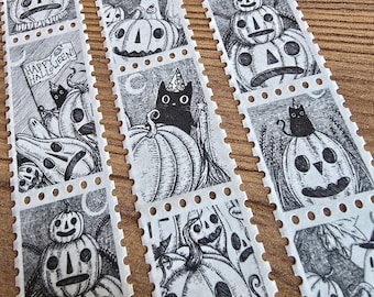 May include: Three vertical strips of perforated postage-style stickers featuring black and white ink illustrations of Halloween themes, including jack-o'-lanterns, ghosts, and black cats wearing party hats, with one stamp reading Happy Halloween.