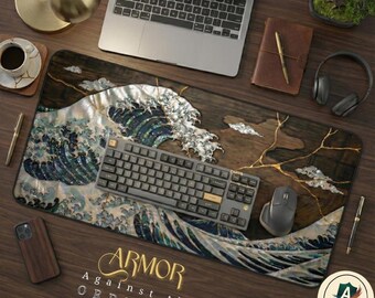 May include: A rectangular desk mat featuring a stylized depiction of a large ocean wave with iridescent shell-like textures and gold-colored accents. The text ARMOR AGAINST THE ORDINARY is printed in gold near the bottom edge of the mat.