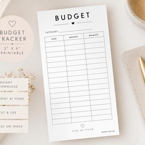 May include: A white rectangular budget tracker sheet featuring the word BUDGET at the top with a small heart icon. The grid includes columns for DATE, AMOUNT, and BALANCE. The bottom includes a small heart and the text stay on track and QUEEN DOLLAR.