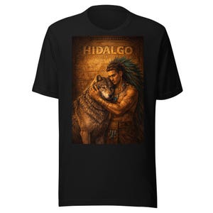 May include: Black t-shirt with a graphic of a person and a wolf, with the word "HIDALGO" above. The graphic is detailed, with the person wearing traditional adornments and the wolf's fur rendered realistically.