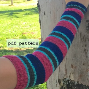 May include: Striped arm warmers in pink, blue, teal, and gray. The arm warmers are knitted and have a pdf pattern.