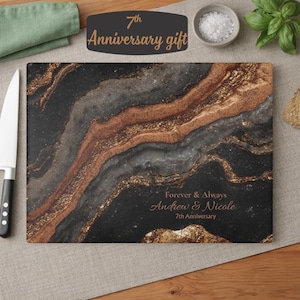 May include: A rectangular glass cutting board featuring a black, gray, and copper-colored marbled pattern. The text "Forever & Always Andrew & Nicole 7th Anniversary" is printed in the lower right corner in a copper-colored script and serif font.