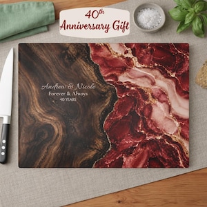 May include: A rectangular cutting board featuring a split design of dark brown wood grain on the left and deep red marble with gold veining on the right. The text reads Andrew & Nicole, Forever & Always, 40 YEARS, with 40th Anniversary Gift above.