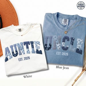 May include: A white t-shirt with the blue patchwork-style text AUNTIE EST. 2026 and a blue t-shirt with the blue patchwork-style text UNCLE EST. 2026. Both shirts feature a Comfort Colors label at the neck and a circular Faux Patch Work logo.