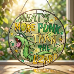 May include: Round stained glass window with a green lizard wearing a crown, with the text "WHAT'S MORE PUNK THAN THE LIZARD" in yellow and green. The window is framed with a black metal chain.
