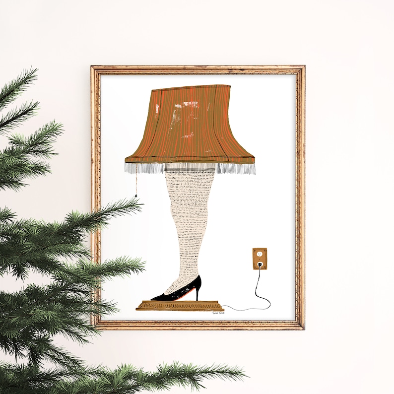 May include: A framed illustration of a lamp with a red and orange shade and a white patterned leg. The lamp is plugged into an outlet and has a cord.
