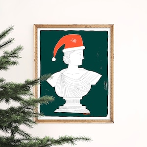 May include: A white line drawing of a bust sculpture wearing a red Santa hat against a dark green background. The artwork is framed in a gold frame.
