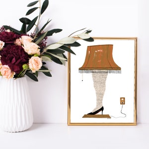 May include: A framed illustration of a lampshade with a human leg and foot, wearing a black shoe. The lampshade is orange and brown with a fringe trim. The illustration is on a white background.