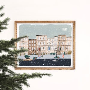 May include: A digital illustration of a snowy city street with brown brick buildings decorated with Christmas lights and wreaths. People are walking down the street, and a car is driving by. The illustration is framed in a gold frame.