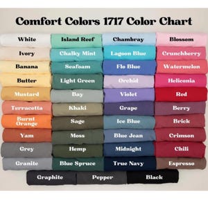 May include: Color chart displaying Comfort Colors 1717 shades. The chart features a variety of colors, including white, ivory, banana, butter, mustard, terracotta, burnt orange, yam, grey, granite, island reef, chalky mint, seafoam, light green, bay, khaki, sage, moss, hemp, blue spruce, graphite, pepper, chambray, lagoon blue, flo blue, orchid, violet, grape, ice blue, blue jean, midnight, true navy, blossom, crunchberry, watermelon, heliconia, red, berry, brick, crimson, chili, espresso, and black.