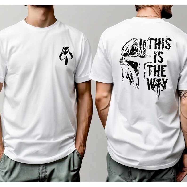May include: A white short-sleeved t-shirt featuring a small black graphic of a helmet on the front left chest. The back of the shirt displays a large black graphic of a helmet with the text THIS IS THE WAY in a distressed, bold font.